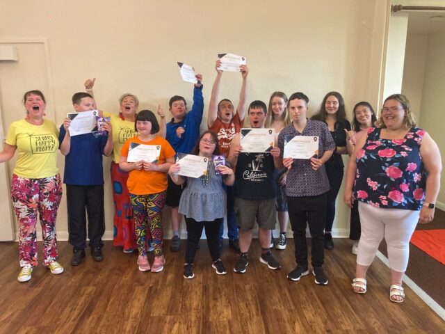 Young people from Skills and Volunteering Cymru, holding up certificates