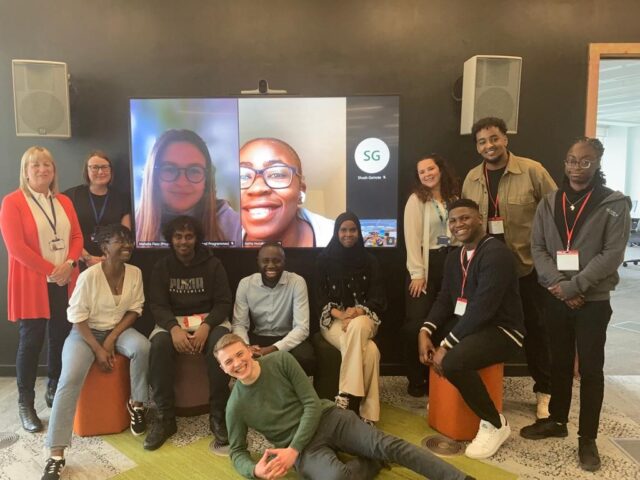 Image of Future Communities Collective, two of our trustees, and colleagues from the Co-op Foundation and HUDL. Some of the people are on a screen behind people, on a video call.