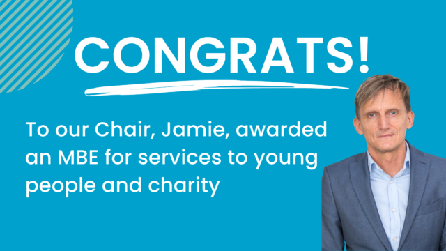 A banner with white text on blue background. It says 'Congrats to our chair, Jamie, awarded an MBE for services to young people and charity. There is also a photo of Jamie
