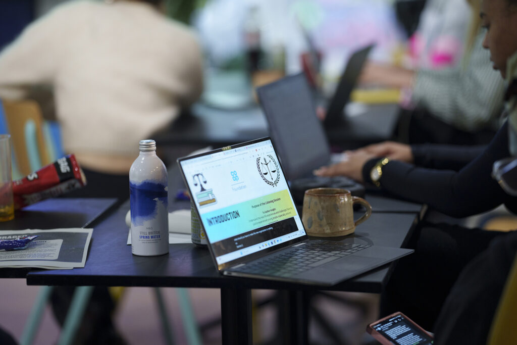 Picture of a laptop with the Co-op Foundation logo on and a few justice organisation logos on.