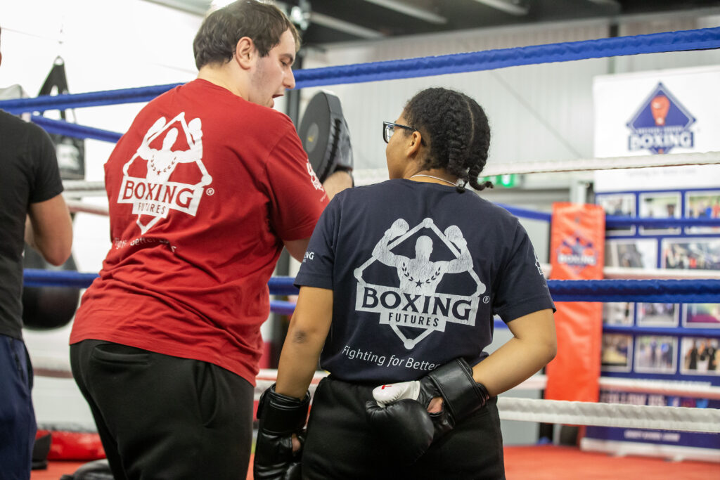 Two young people at Boxing Futures, supporting each other to help their physical and mental health and wellbeing. 