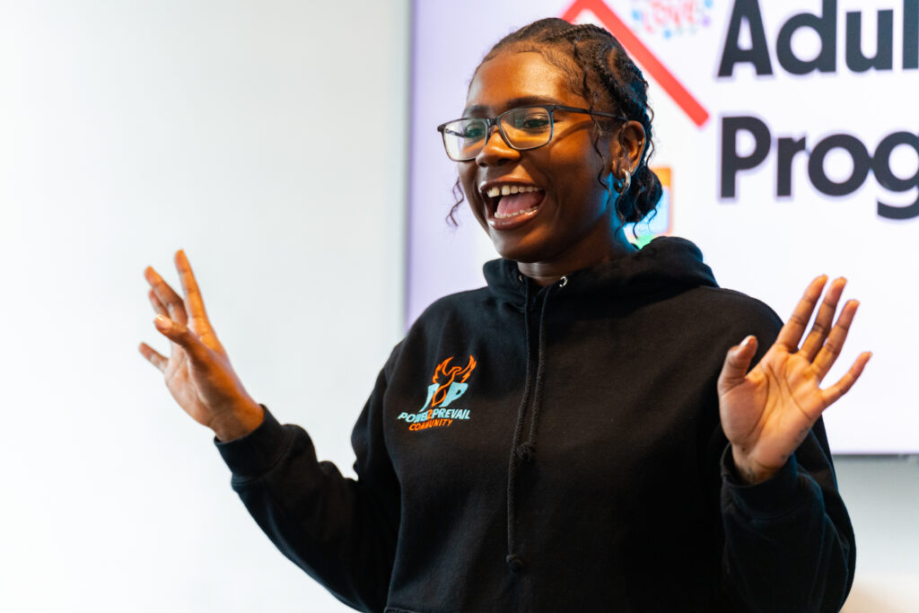 Young woman smiling with hands in the air
