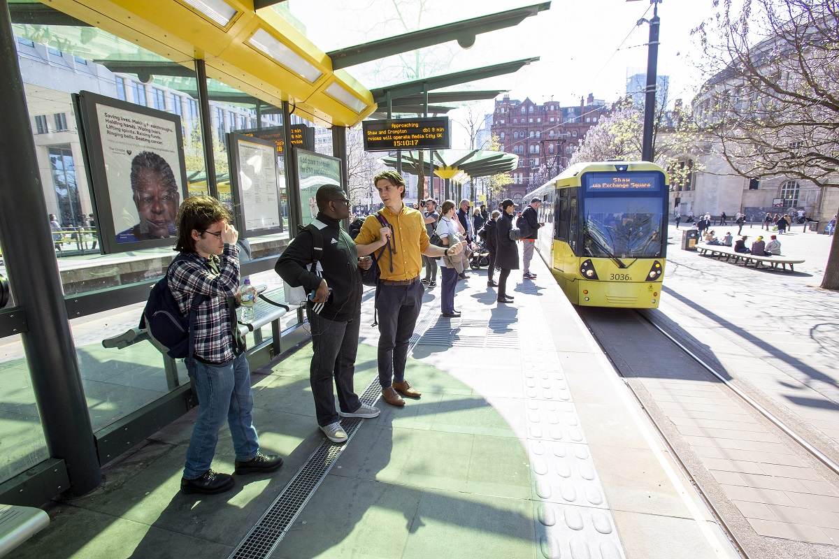 GMYN young people and support worker waiting for tram