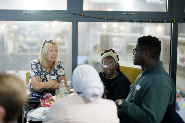 Four people talking around a table