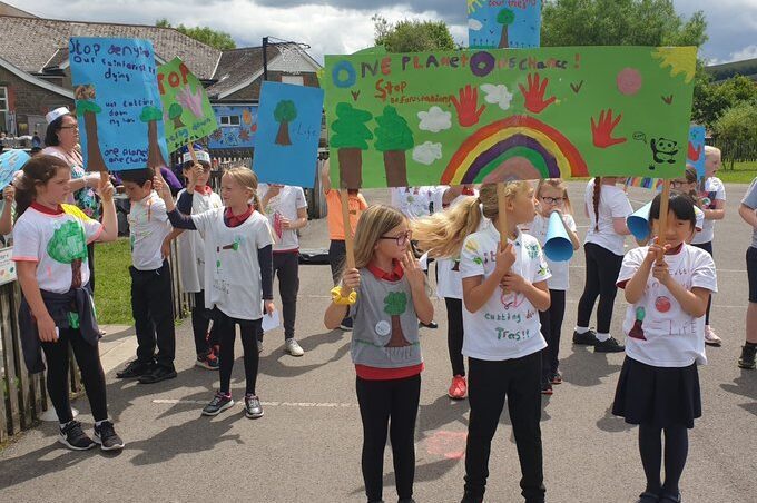 Children holding environmental placards